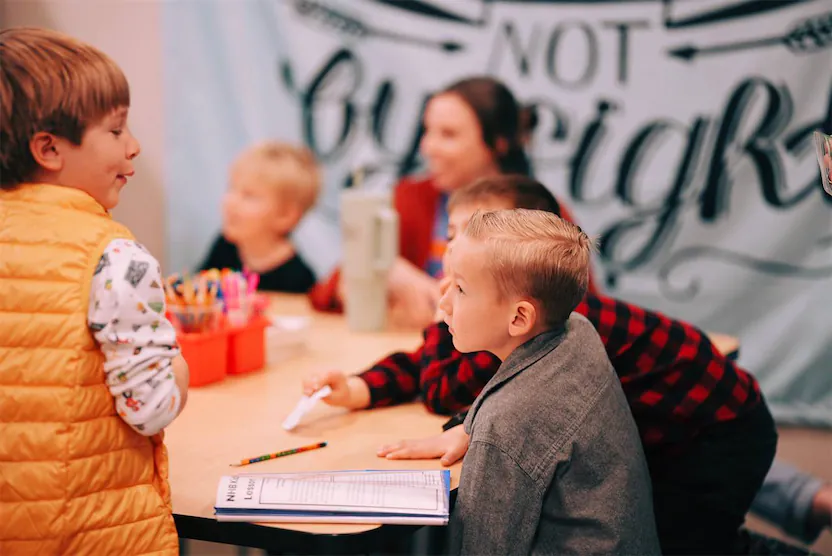 Kids sitting at a table during class