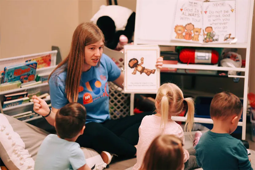 volunteer holding picture during story time.