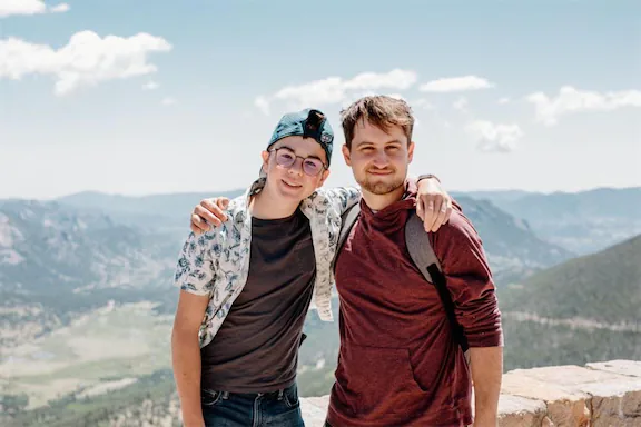 To guys taking a photo at a scenic over look